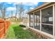 View of the large backyard with a screened in porch and wooden fence at 11247 Reflection Point Dr, Fishers, IN 46037