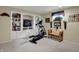 Finished basement area with carpeting, built-in bookcases, exercise equipment and decor at 11247 Reflection Point Dr, Fishers, IN 46037