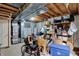Unfinished basement with exposed ceiling, storage shelves and various household items at 11247 Reflection Point Dr, Fishers, IN 46037