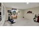 Finished basement area with carpeting, built-in bookcases, exercise equipment and decor at 11247 Reflection Point Dr, Fishers, IN 46037