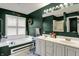 A spacious bathroom with double sinks, shower, and a soaking tub under a window with white blinds at 11247 Reflection Point Dr, Fishers, IN 46037