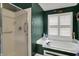 A bathroom featuring a glass shower, and a soaking tub under a window with white blinds at 11247 Reflection Point Dr, Fishers, IN 46037