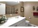 Neutral bathroom with a white vanity, decorative sconces, and a framed mirror over the sink at 11247 Reflection Point Dr, Fishers, IN 46037