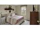 A bedroom with neutral carpet, off-white walls, and a queen-sized bed at 11247 Reflection Point Dr, Fishers, IN 46037