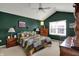 Main bedroom featuring a vaulted ceiling, window, and a neutral carpet and dark green walls at 11247 Reflection Point Dr, Fishers, IN 46037