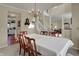 Elegant dining room featuring chandelier lighting and open layout to the living area at 11247 Reflection Point Dr, Fishers, IN 46037