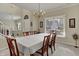 Bright dining room with large windows and an open layout to the staircase at 11247 Reflection Point Dr, Fishers, IN 46037