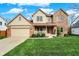 Charming two-story brick home with a well-manicured lawn and inviting front porch at 11247 Reflection Point Dr, Fishers, IN 46037
