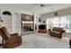 Cozy living room with brick fireplace, built-in shelving, and comfortable seating at 11247 Reflection Point Dr, Fishers, IN 46037