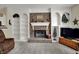 Bright living room with brick fireplace, built-in shelves, and comfortable seating at 11247 Reflection Point Dr, Fishers, IN 46037