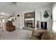 Spacious living room with a brick fireplace, built-in shelving, and lots of light at 11247 Reflection Point Dr, Fishers, IN 46037
