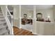 Inviting living room with hardwood floors, neutral paint, and decorative columns at 11247 Reflection Point Dr, Fishers, IN 46037