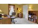 Office room with yellow walls, neutral carpet, a window, desk, office chair, and a bookshelf at 11247 Reflection Point Dr, Fishers, IN 46037
