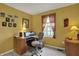 Office with yellow walls featuring a desk, a window, an office chair, and neutral carpet at 11247 Reflection Point Dr, Fishers, IN 46037