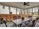 Inviting sunroom features screened windows, a dining table set, and views of the backyard at 11247 Reflection Point Dr, Fishers, IN 46037