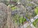 Aerial view of a neighborhood with houses surrounded by trees in a secluded and natural environment at 11921 Westwood Dr, Carmel, IN 46033