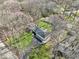 Aerial view of home with well-maintained lawn, surrounded by a canopy of trees in a tranquil setting at 11921 Westwood Dr, Carmel, IN 46033