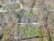 Aerial view showcases a cozy home surrounded by trees, blending seamlessly into the natural setting at 11921 Westwood Dr, Carmel, IN 46033