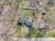 Aerial view of the property featuring the home's roof, driveway, and surrounding trees at 11921 Westwood Dr, Carmel, IN 46033