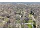 An aerial view showcases a home nestled among trees, offering a sense of privacy and seclusion at 11921 Westwood Dr, Carmel, IN 46033