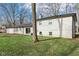 A spacious backyard features an exposed brick home, a paver patio, a grassy lawn and bare trees at 11921 Westwood Dr, Carmel, IN 46033
