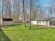 Spacious backyard with a lush green lawn, a storage shed, and a brick patio connected to the home at 11921 Westwood Dr, Carmel, IN 46033