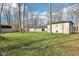 A spacious backyard features an exposed brick home, a paver patio, a grassy lawn and bare trees at 11921 Westwood Dr, Carmel, IN 46033
