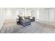 Large finished basement area with gray sectional, white walls, and ample lighting at 11921 Westwood Dr, Carmel, IN 46033