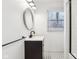 Bathroom featuring a black vanity, patterned tile floor, and chrome fixtures at 11921 Westwood Dr, Carmel, IN 46033
