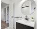 Bright bathroom with black vanity, large mirror, and patterned tile floor at 11921 Westwood Dr, Carmel, IN 46033