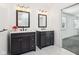 Bathroom featuring double vanity with dark cabinets and white countertops at 11921 Westwood Dr, Carmel, IN 46033