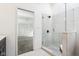 Bathroom featuring tiled shower with glass door and a view into bedroom at 11921 Westwood Dr, Carmel, IN 46033