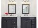 Bathroom featuring double vanity with dark cabinets and white countertops at 11921 Westwood Dr, Carmel, IN 46033