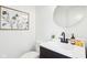 Stylish powder room with round mirror, modern vanity, and elegant decor at 11921 Westwood Dr, Carmel, IN 46033