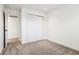 Spacious bedroom with carpet, bi-fold closet, and neutral paint at 11921 Westwood Dr, Carmel, IN 46033