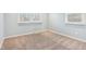 Bedroom featuring neutral carpet, two windows, and white trim at 11921 Westwood Dr, Carmel, IN 46033