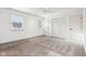 Spacious bedroom featuring carpet, ceiling fan, windows, and closet at 11921 Westwood Dr, Carmel, IN 46033