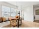 Charming breakfast nook featuring a built-in bench, round table, and natural light from a window at 11921 Westwood Dr, Carmel, IN 46033