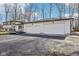 Three car garage attached to a well maintained white brick home at 11921 Westwood Dr, Carmel, IN 46033