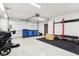 Spacious garage with white walls, an open garage door, and a pull-up bar and weights for a home gym at 11921 Westwood Dr, Carmel, IN 46033