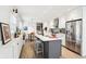 Updated kitchen with island seating, stainless appliances, white cabinets, and adjacent breakfast nook at 11921 Westwood Dr, Carmel, IN 46033