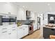 Well-lit kitchen boasts stainless steel appliances, stylish cabinetry, and easy access to living area at 11921 Westwood Dr, Carmel, IN 46033