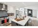 Contemporary kitchen with stainless steel appliances, kitchen island, and an adjacent fireplace feature at 11921 Westwood Dr, Carmel, IN 46033