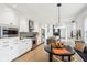 Well-equipped kitchen featuring stainless steel appliances, white cabinets, kitchen island, and breakfast table at 11921 Westwood Dr, Carmel, IN 46033