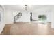 Bright living room with wood floors, modern lighting, fireplace, and staircase at 11921 Westwood Dr, Carmel, IN 46033