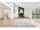 Living room with vaulted ceilings, wood floors, fireplace, and sliding doors to the backyard at 11921 Westwood Dr, Carmel, IN 46033