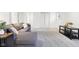 Cozy living room features a grey couch, area rug, and a black end table at 11921 Westwood Dr, Carmel, IN 46033