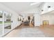 View from living room to kitchen with breakfast bar, stainless steel appliances, and slider to the yard at 11921 Westwood Dr, Carmel, IN 46033