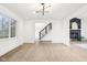 Bright living room featuring wood floors, modern lighting, and a staircase with metal railing at 11921 Westwood Dr, Carmel, IN 46033