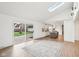 Bright living room with skylight, sliding doors to patio, and open floor plan to the modern kitchen at 11921 Westwood Dr, Carmel, IN 46033